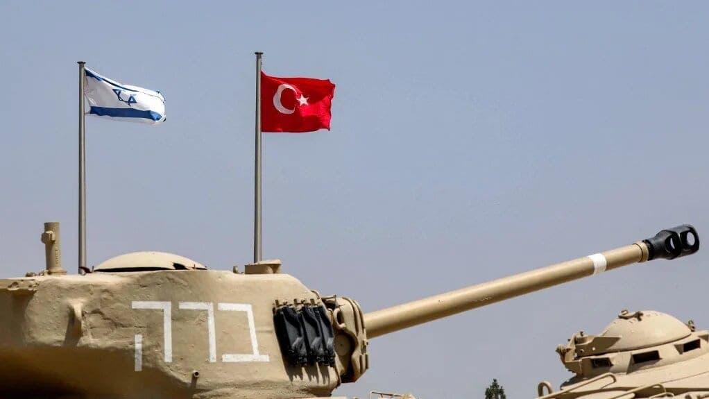 The flags of (L to R) Israel and Turkey fly behind M4A1 Sherman and AMX-13 battle tanks on display at the Yad La-Shiryon Tank Museum in Latrun, about 30 kilometres west of Jerusalem, on August 18, 2022. (GIL COHEN-MAGEN / AFP)