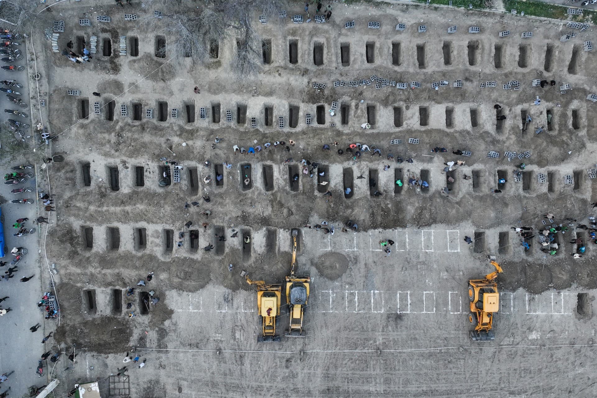 Aerial picture showing mourners digging graves during the funeral for children killed in a strike on a primary school in Minab, Iran (AFP/Iranian Press Centre)
